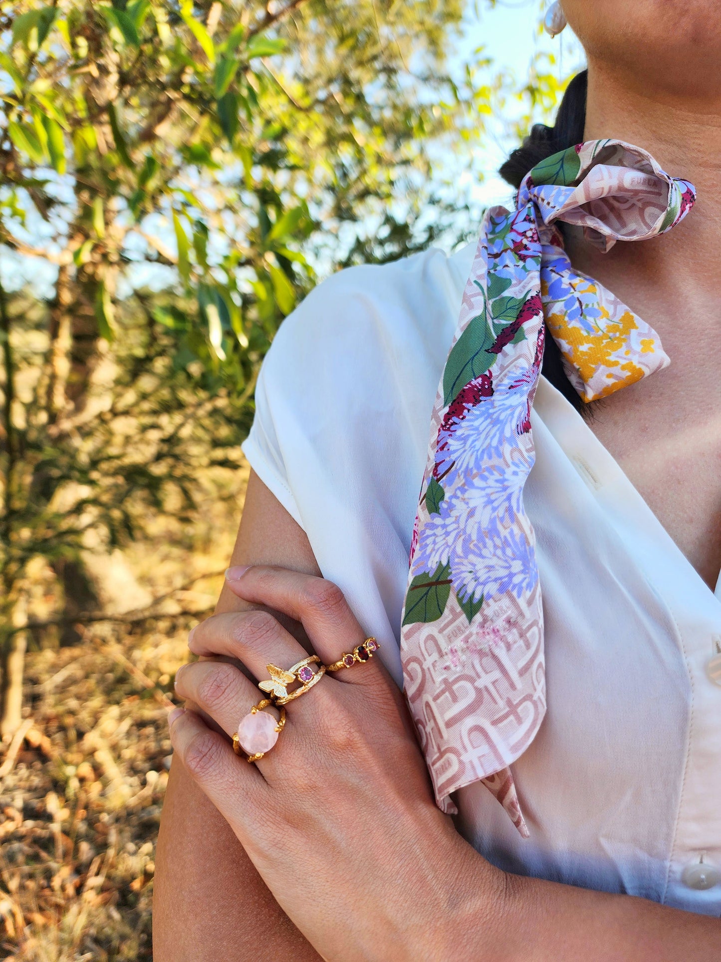 Natural Pink Tourmaline, Rose Quartz and Garnet jewellery, layered ring stack in 20k gold plating. A luxe-bohemian styling shot in the Australian bush, showcasing the hand-sculpted molten bands and vibrant gemstone glow.