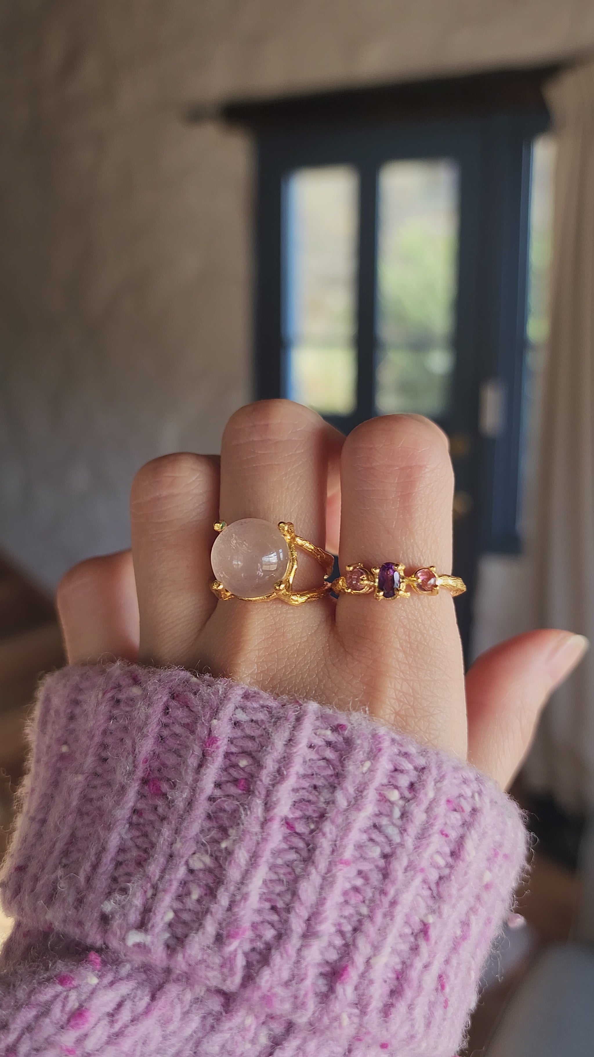 Rose quartz ring styled with an amethyst and pink tourmaline ring, handmade in 20k fine gold plate and worn in a cottage in Tasmania to showcase the Australian inspiration behind the pieces. The hand wearing the rings gently moves to demonstrate fit and illuminates the crystals sparkle.