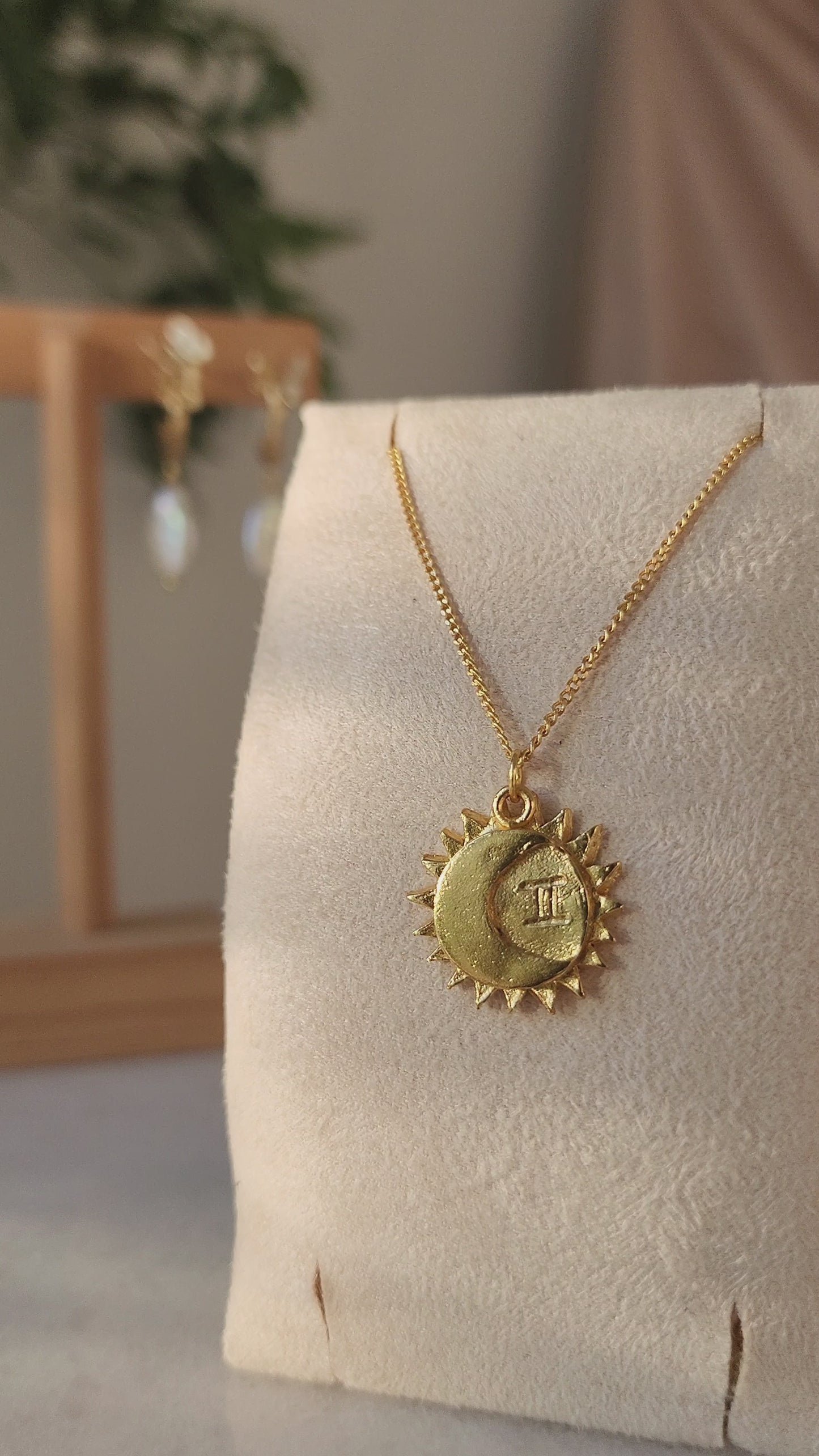Gemini sun and moon star sign necklace made using the lost wax cast process, showcasing the details of the organic textures and hand carved Gemini zodiac synbol.