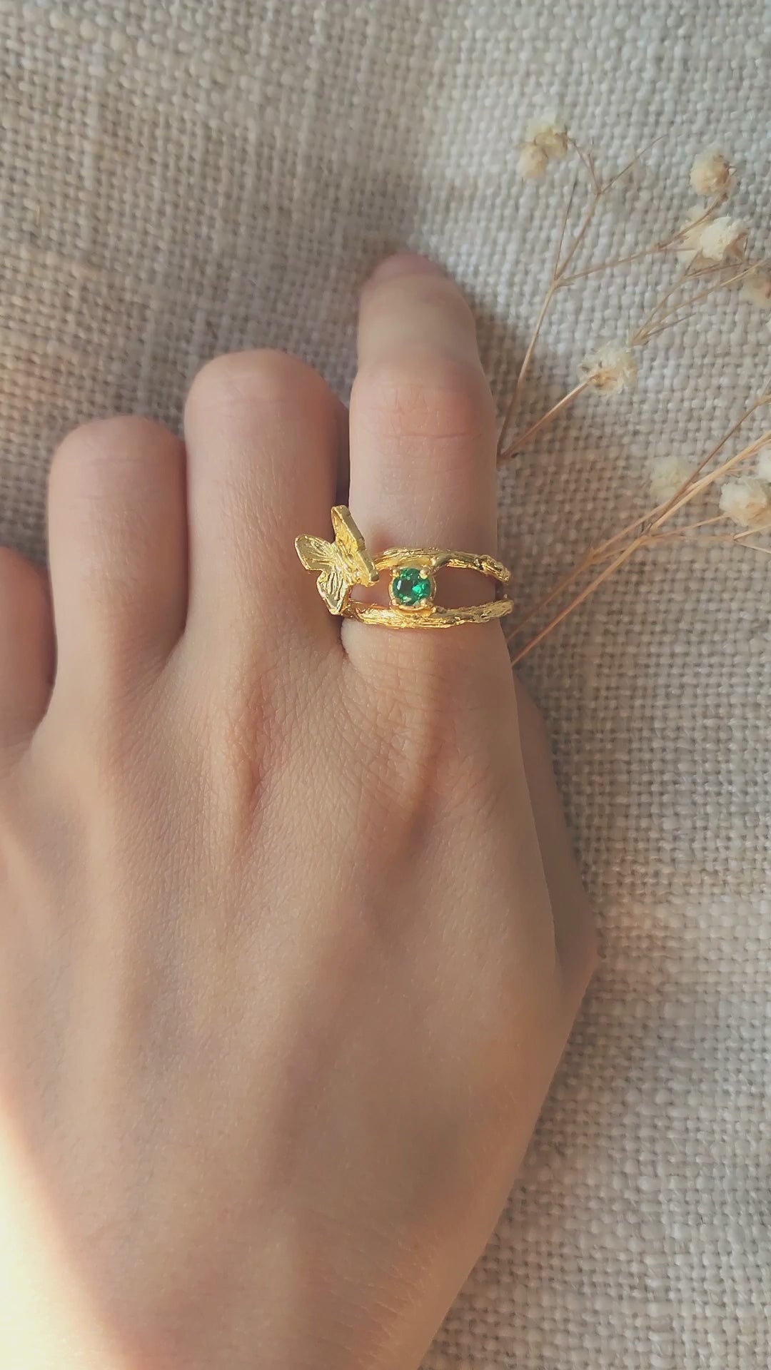 Emerald green butterfly ring, worn on hand, video panning across the hand carved textures and natural green precious gemstone to show scale and movement.